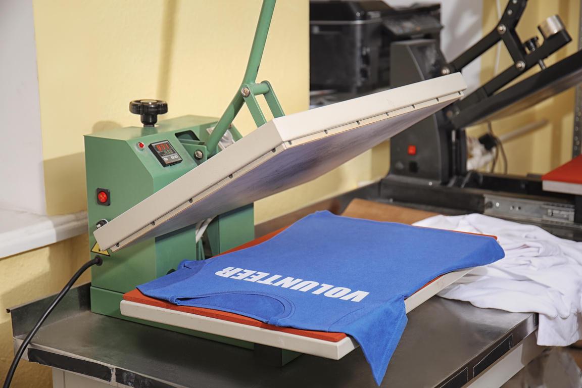 Modern Printing Machine with T-Shirt at Workplace